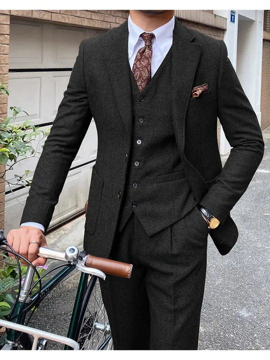 Sophisticated men's textured three-piece suit with paisley tie and pocket square, showcasing refined urban style