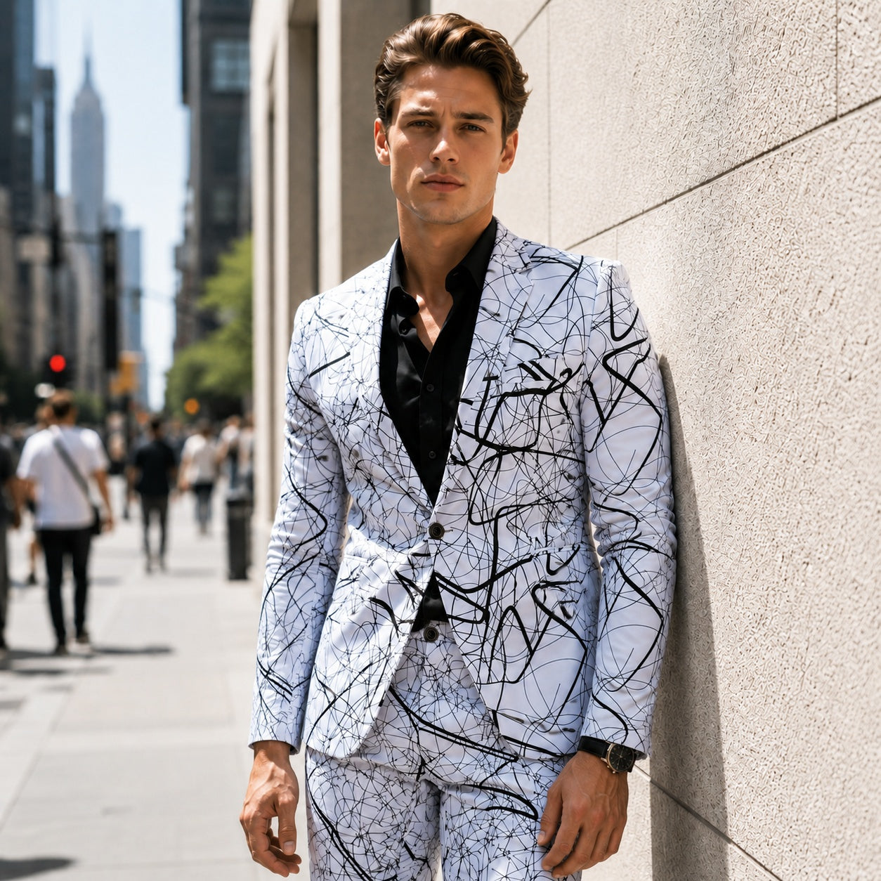 Young man in a slim fit white blazer with black artistic graphic lines walking on a sunny city street.