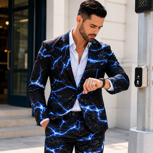 Handsome man wearing a slim fit men's suit with vibrant blue lightning bolt patterns, standing in front of a museum entrance.