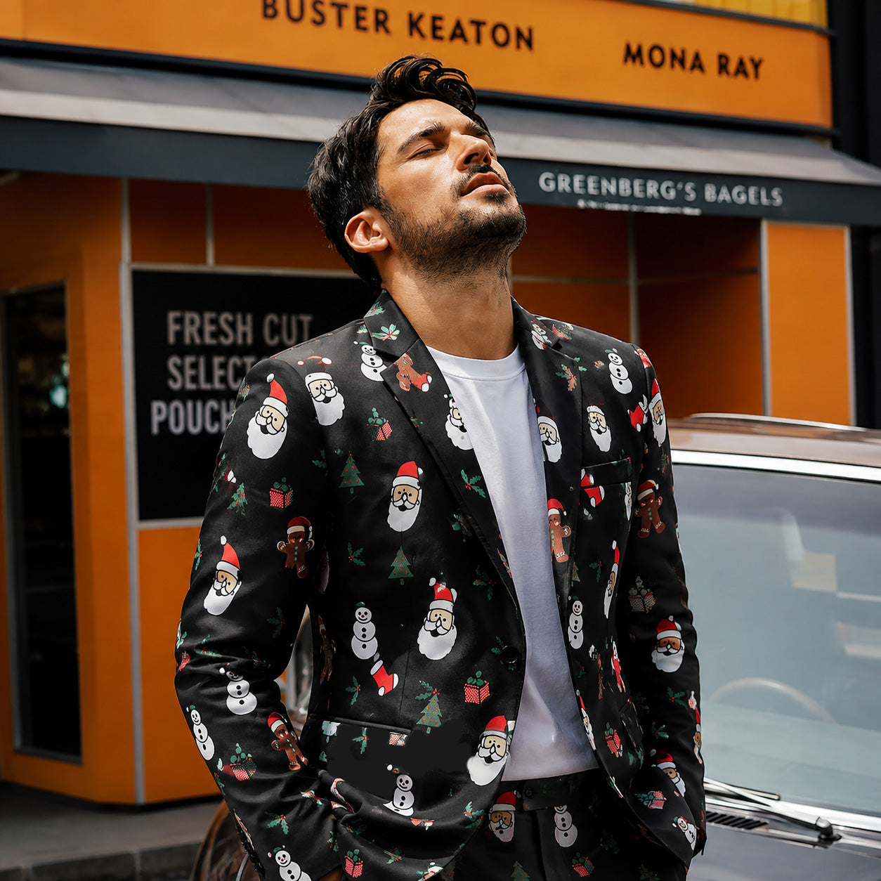 Close-up of a man wearing a black Christmas themed blazer paired with a white t-shirt.