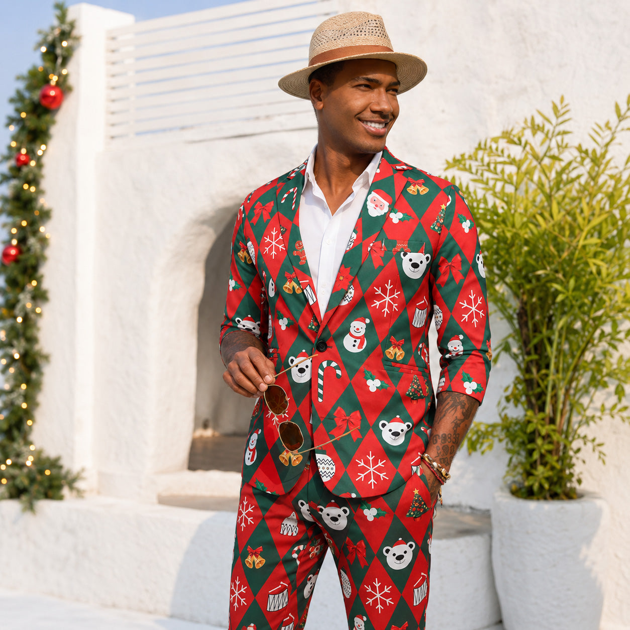 Men's festive red and green Christmas suit set with Santa, snowman, and polar bear print, styled with a sun hat.
