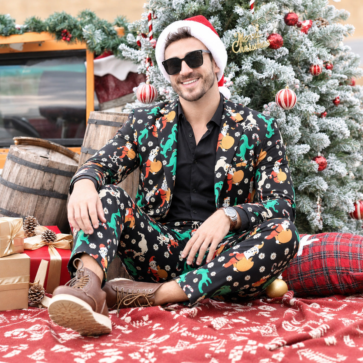 Man sitting near Christmas tree wearing festive printed suit and Santa hat | WISHOLIC