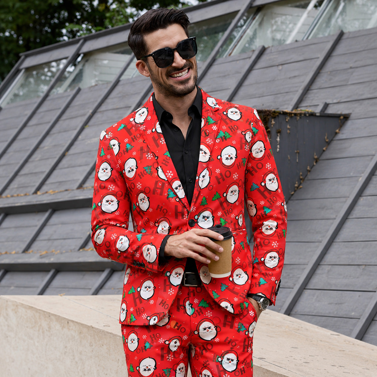 A stylish man wearing a full red Christmas printed suit with sunglasses, holding a coffee cup by WISHOLIC.