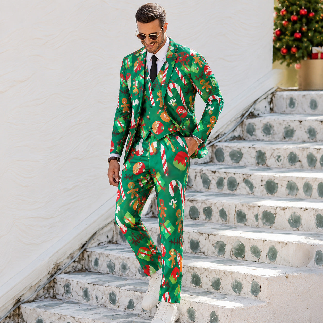 Full length view of men's green festive print 3-piece suit styled with white sneakers by WISHOLIC