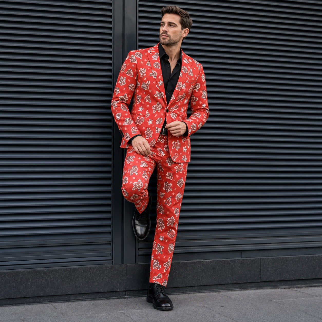 Full body view of a man wearing a red christmas gingerbread patterned suit with black shirt and shoes - WISHOLIC