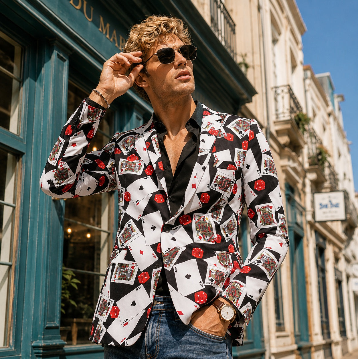 Man wearing a Wisholic playing card print blazer with sunglasses and a black shirt, high-end editorial style.