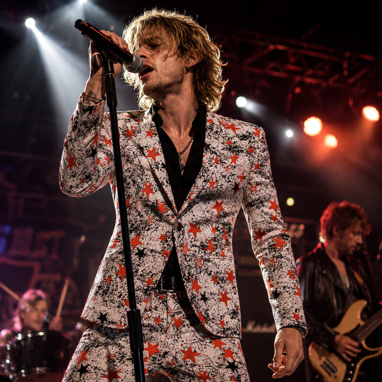 Fashion-forward man at a high-end evening party holding a champagne glass, dressed in an artistic white suit with red star motifs and an unbuttoned black shirt.