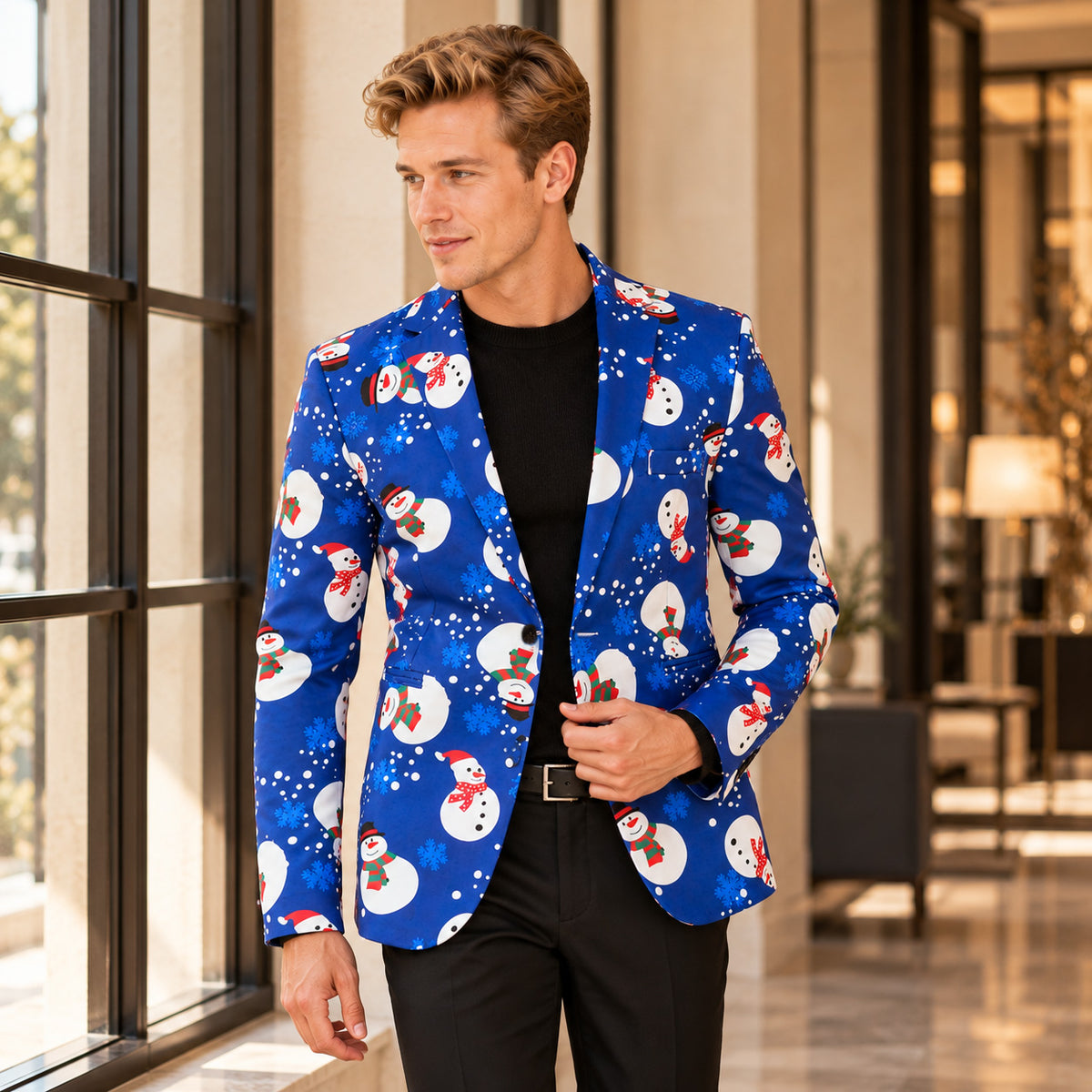 WISHOLIC men's blue snowman print Christmas blazer styled with a black knit sweater and black trousers.