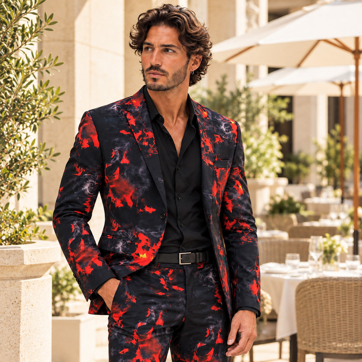WISHOLIC men's crimson red and black flame print statement suit styled with a black shirt at a luxury outdoor terrace