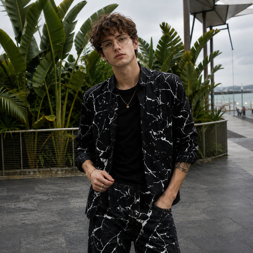 Relaxed summer style featuring a Wisholic marble print shirt paired with dark denim, ideal for a seaside holiday.
