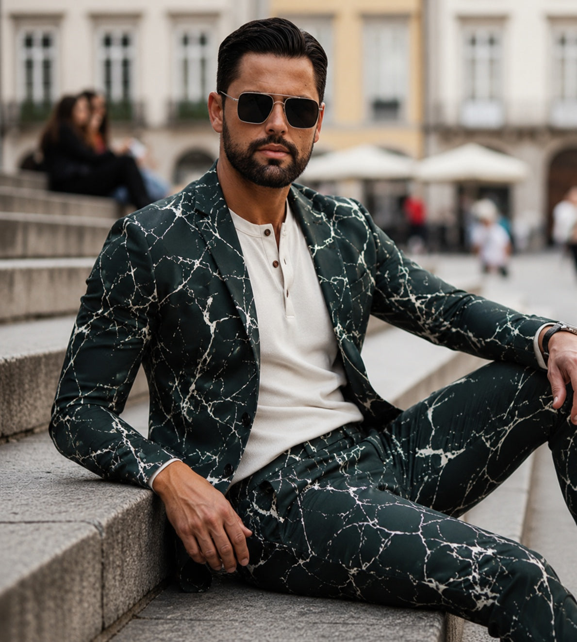Wisholic luxury men's blazer featuring an artistic white crackle pattern on deep green fabric, paired with sunglasses and a cream henley shirt.