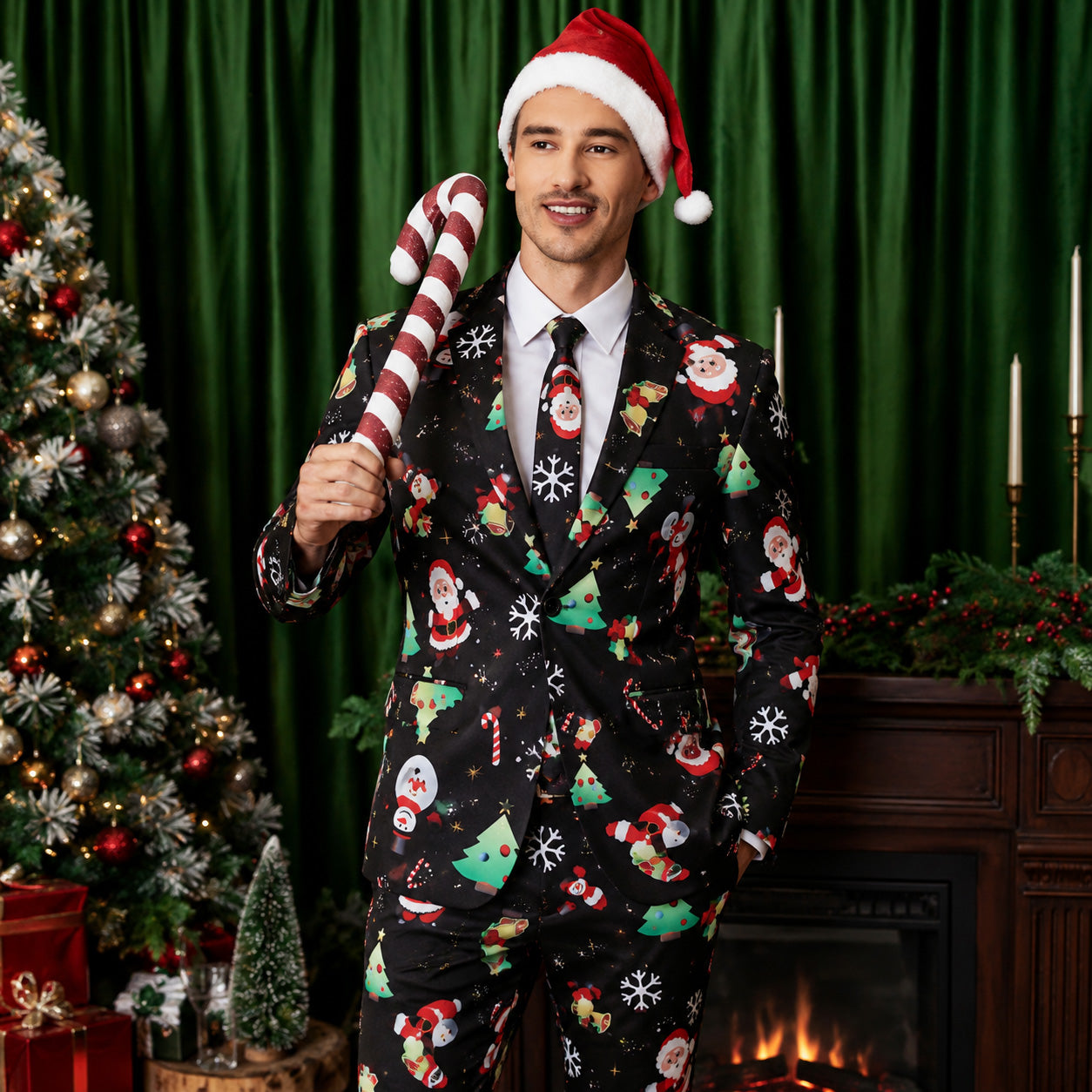 Wisholic men's black ugly Christmas suit featuring Santa, snowman, and Christmas tree prints, holding a large candy cane by the fireplace
