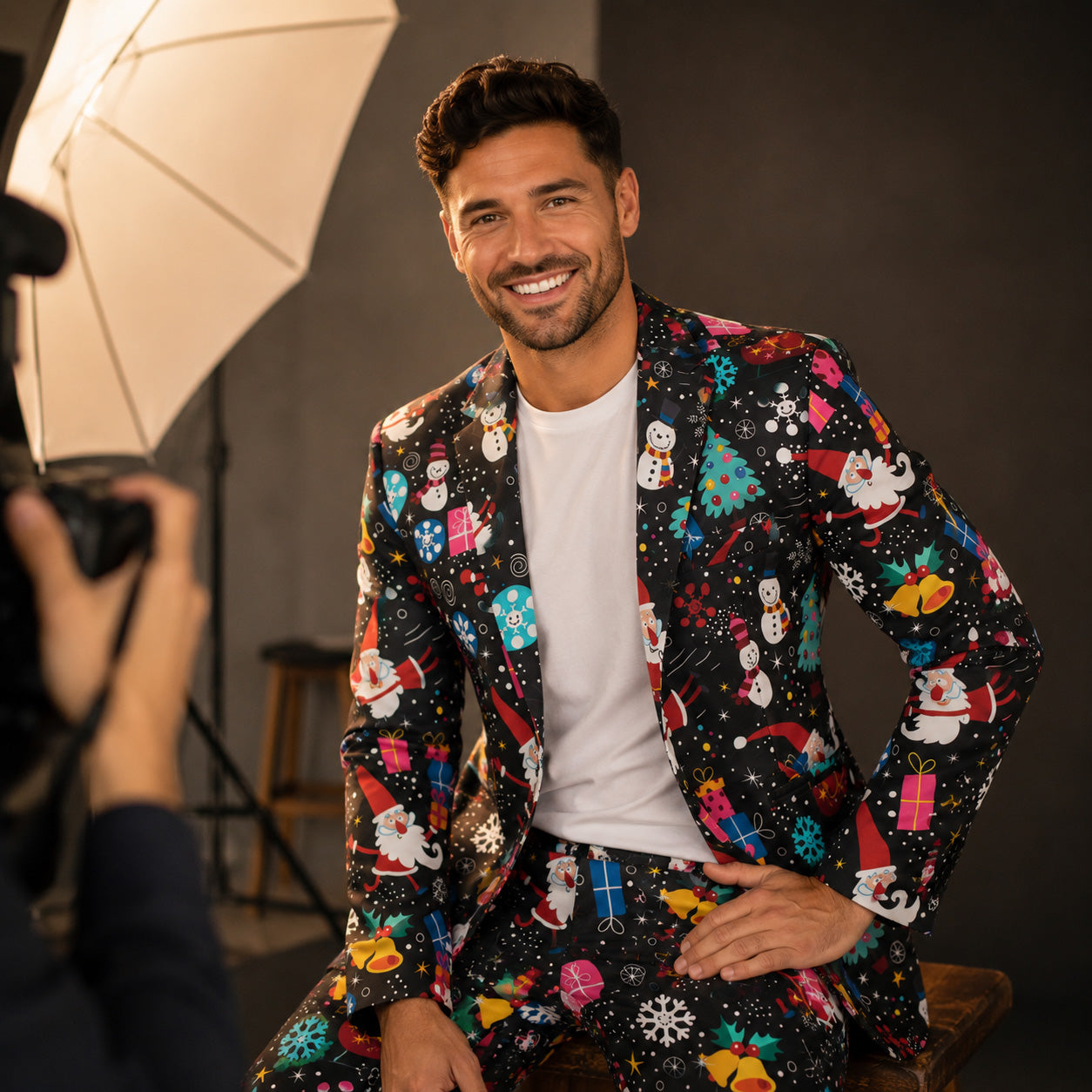 Handsome man smiling in Wisholic black animated Christmas pattern blazer jacket for holiday photoshoot