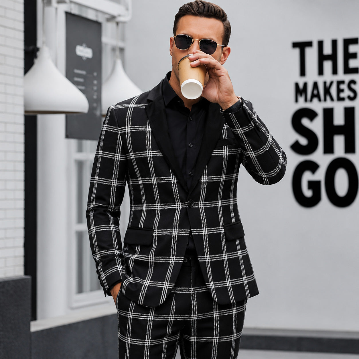 Wisholic 2026 Collection men's black and white plaid suit in a premium slim fit, styled with a black shirt and sunglasses for an editorial high-street dapper look.