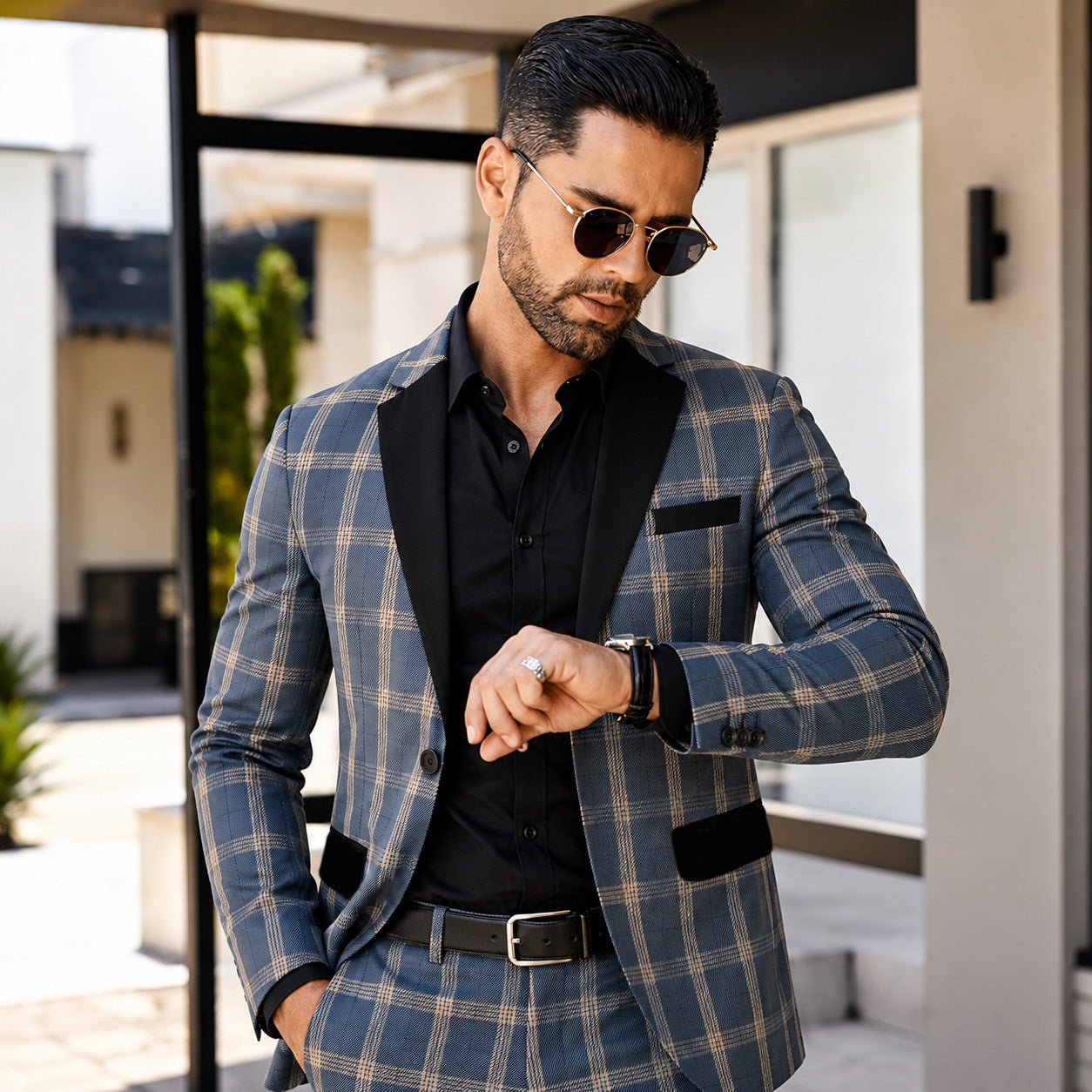 Wisholic 2026 Collection men's blue and khaki windowpane plaid suit in a sharp slim fit, styled with a black shirt and sunglasses for an editorial streetwear look.