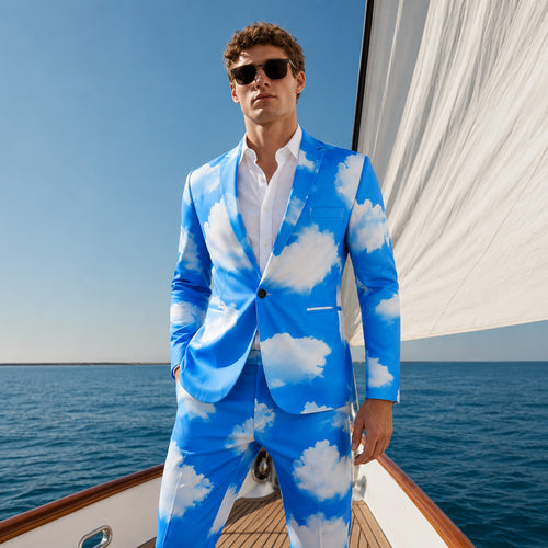 A male model wearing the WISHOLIC men's blue sky and white cloud print suit, posing confidently on a luxury yacht with a blue ocean background.