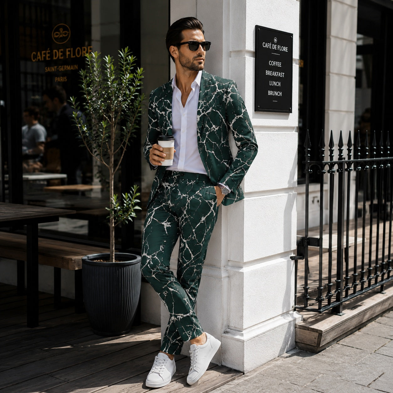 Wisholic men's emerald green marble printed suit in a perfect slim fit, styled with a white shirt and sneakers outside a Parisian cafe.