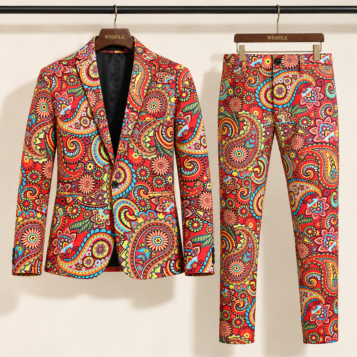 Wisholic 2-piece men's festive suit set featuring colorful red and yellow paisley pattern blazer and matching trousers on hangers