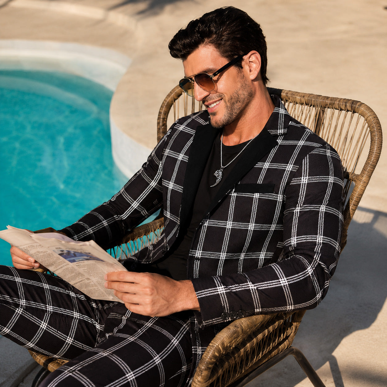Modern men's fashion luxury styling featuring the Wisholic black plaid suit blazer paired casually with a t-shirt by the pool.