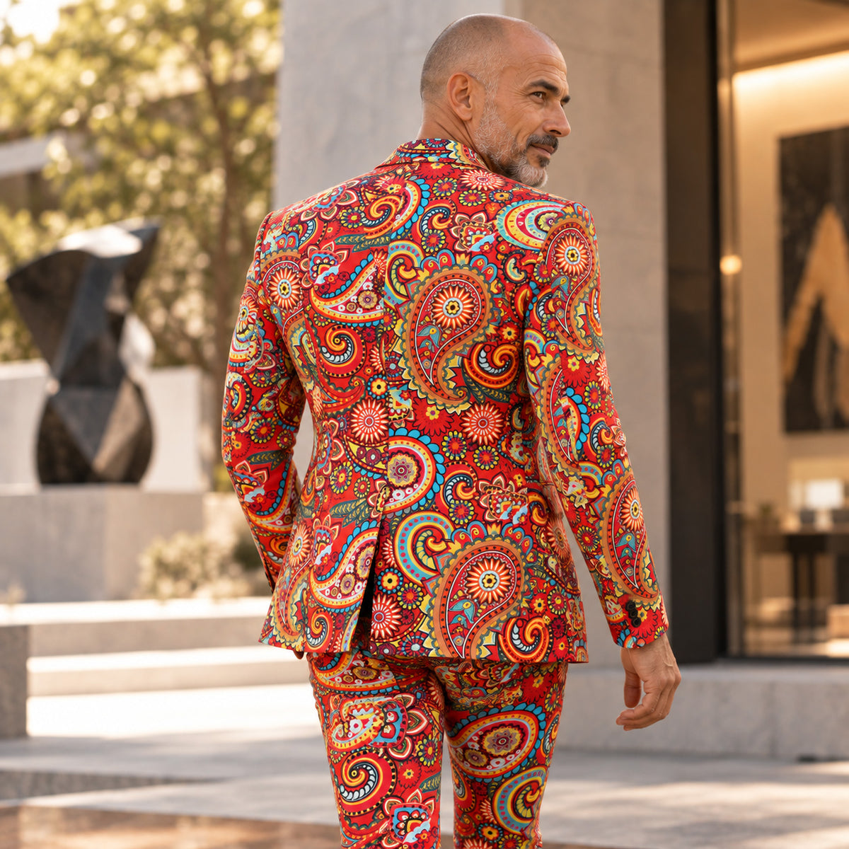 Back view of Wisholic men's vibrant red paisley printed suit jacket and trousers
