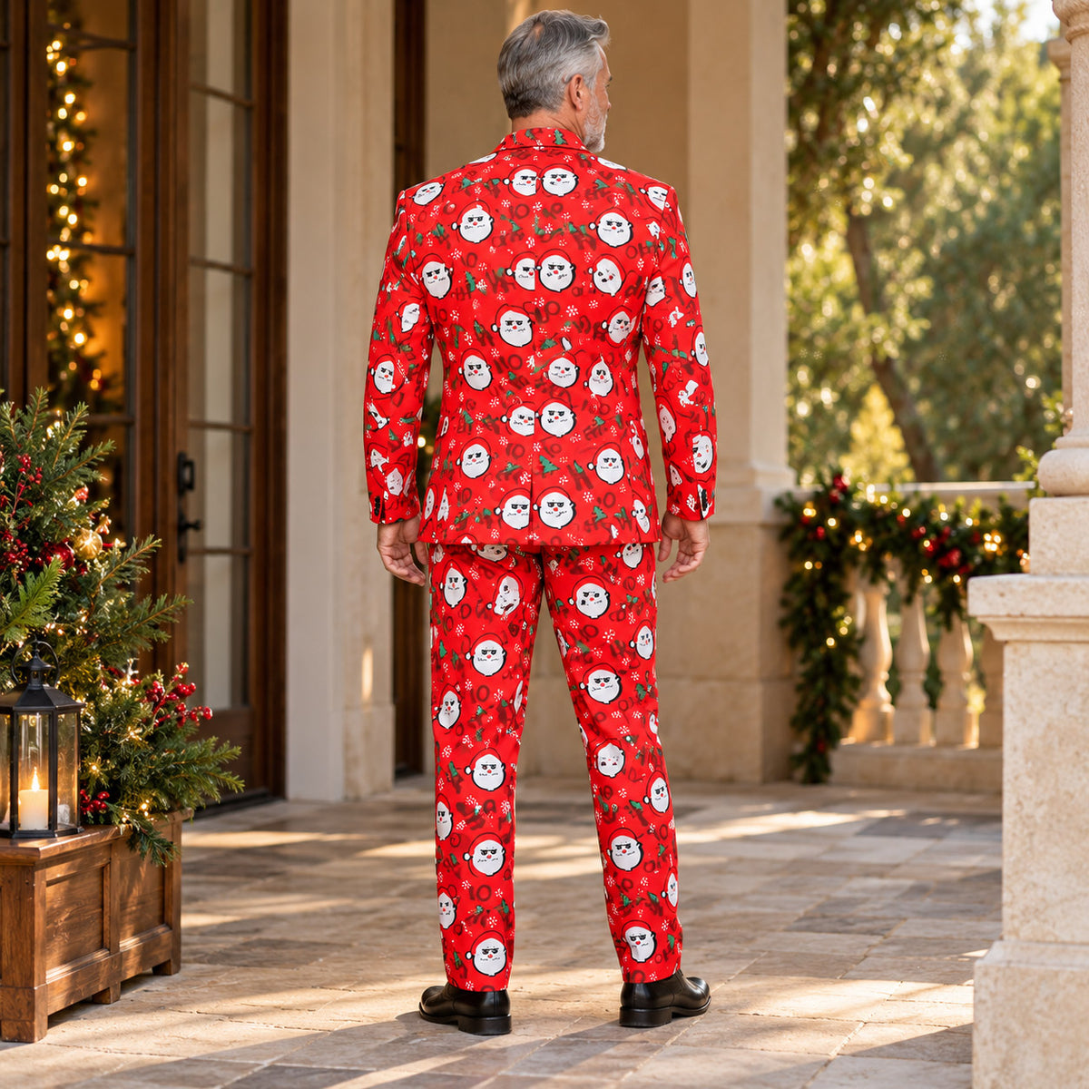 Back view of Wisholic men's red festive suit jacket and tailored pants with repeating Santa graphics in a holiday outdoor patio setting.