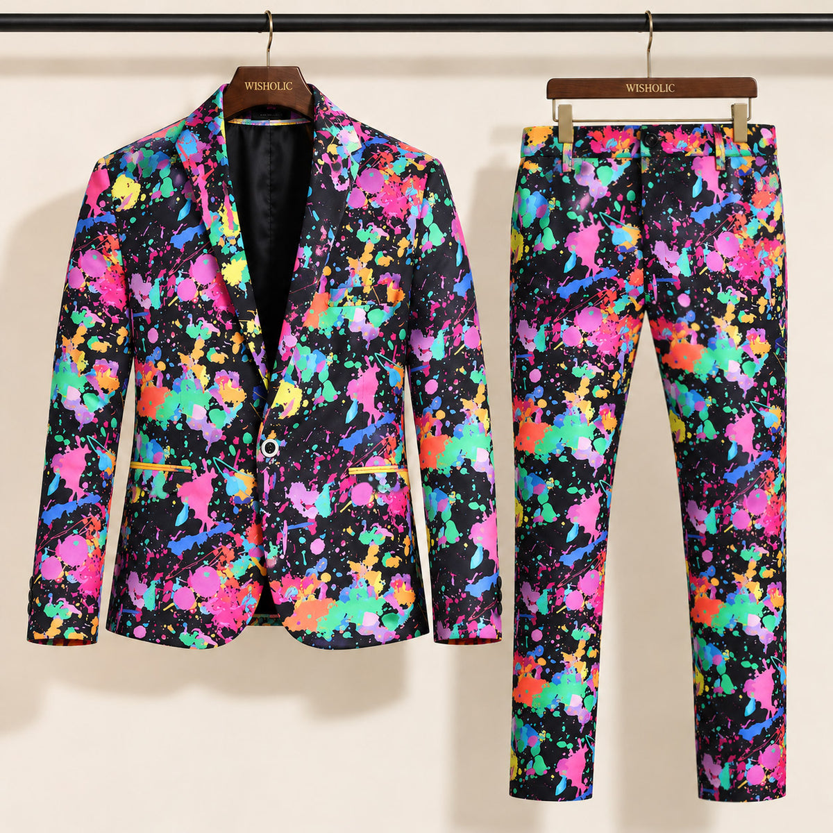 Wisholic neon paint splash printed two-piece suit with blazer and trousers hanging on wooden hangers