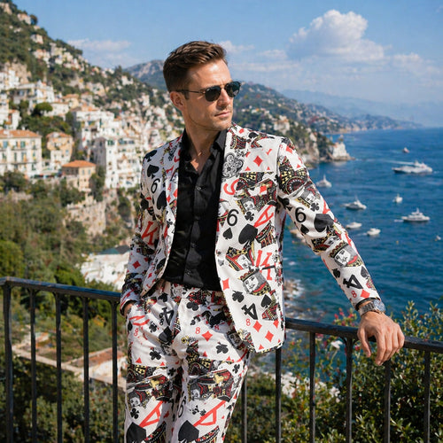 Side view of Wisholic playing card print blazer and matching trousers with a scenic ocean and hillside background.