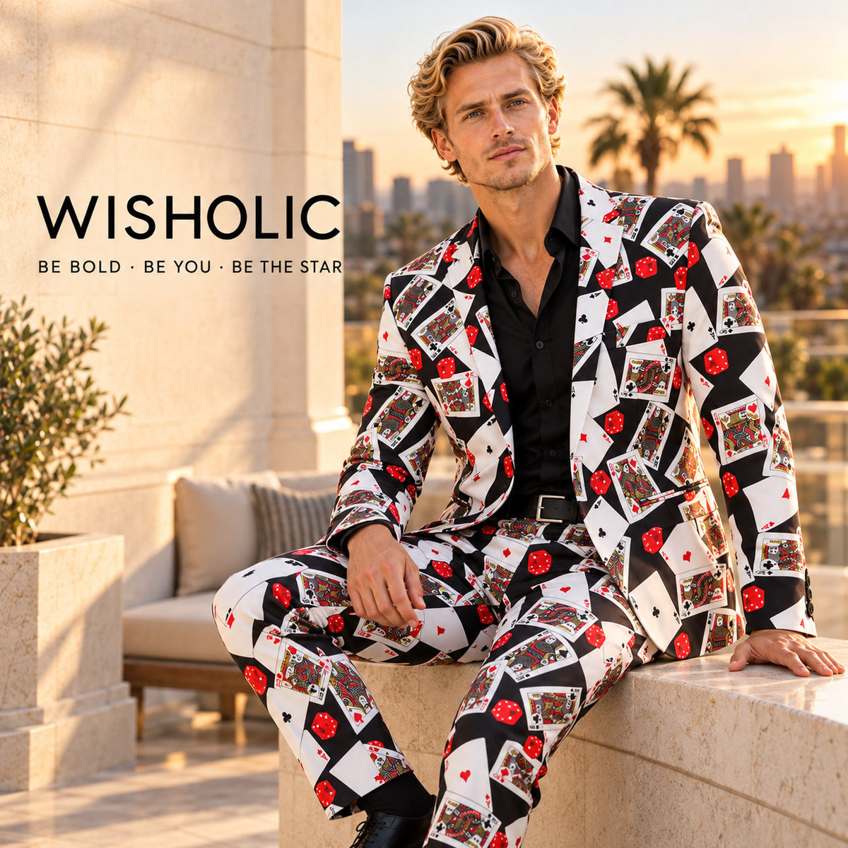 WISHOLIC playing card print two-piece suit worn by a seated male model on a sunset terrace with the WISHOLIC brand signature.