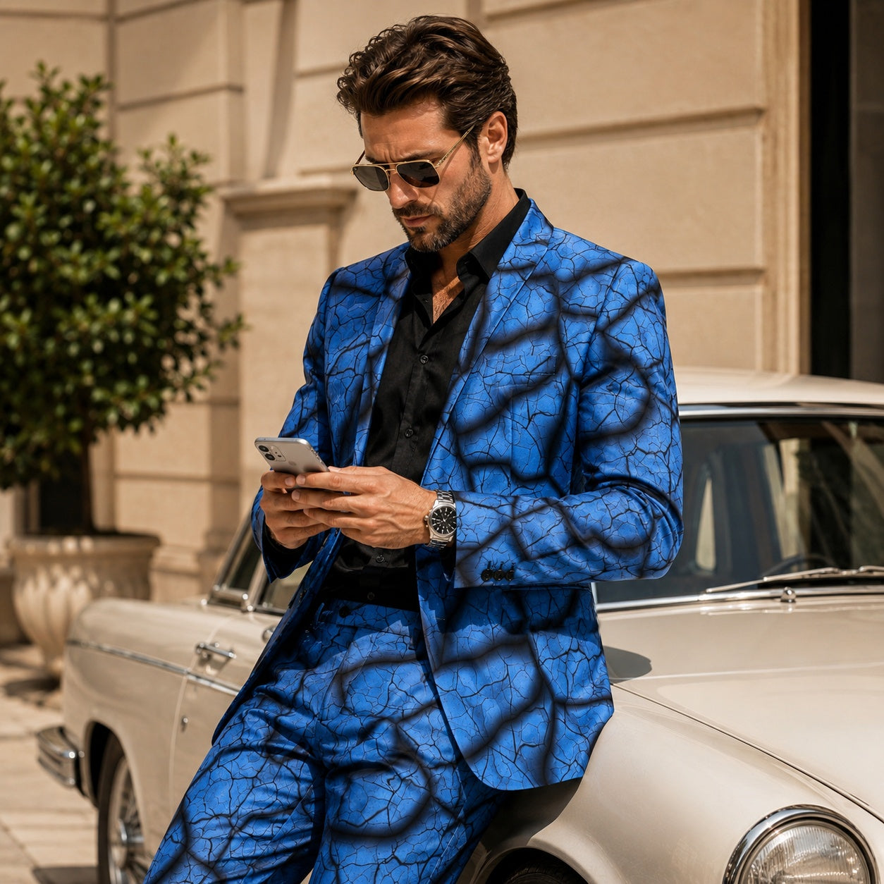 A man wearing the WISHOLIC artistic blue blazer with sunglasses, leaning against a classic car, showcasing a luxury lifestyle aesthetic.