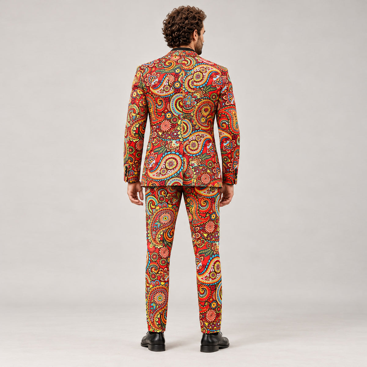 Back view of WISHOLIC men's red paisley two-piece suit showing the colorful floral print across the blazer and matching trousers.